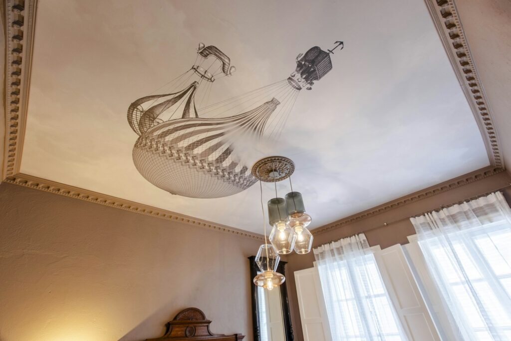 Bedroom with a chandelier and a decorative painting covering the ceiling