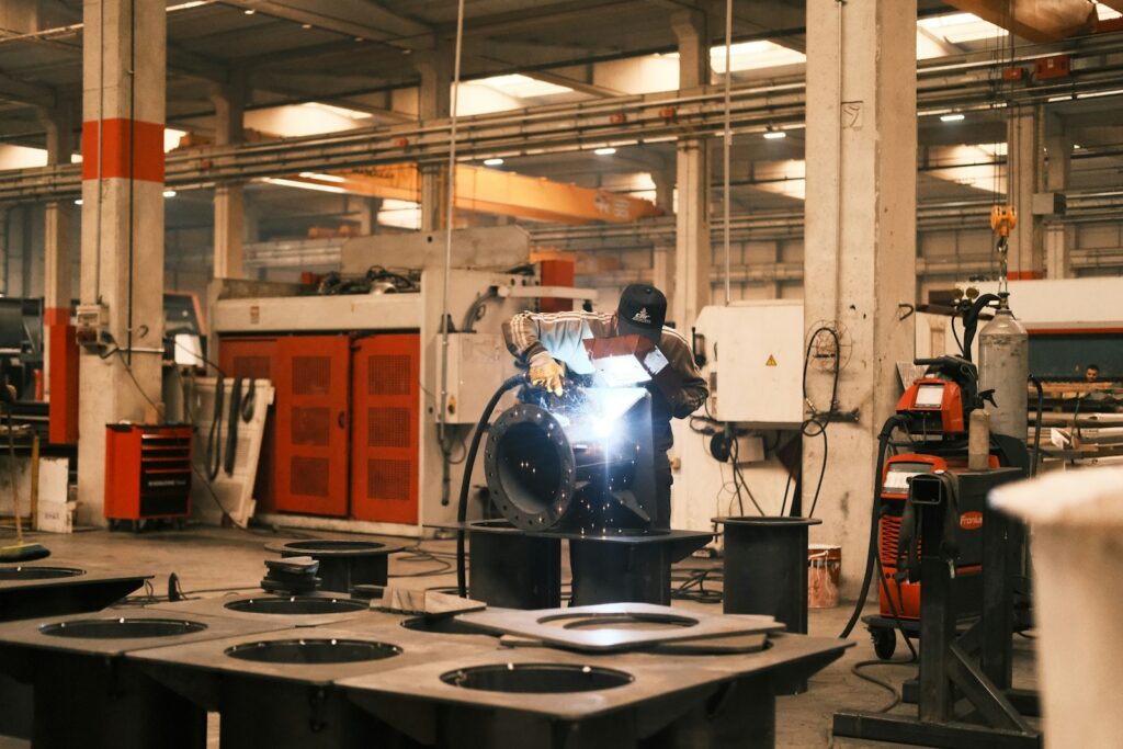 Factory worker welding a piece of metal, a hands-on approach to metal repair
